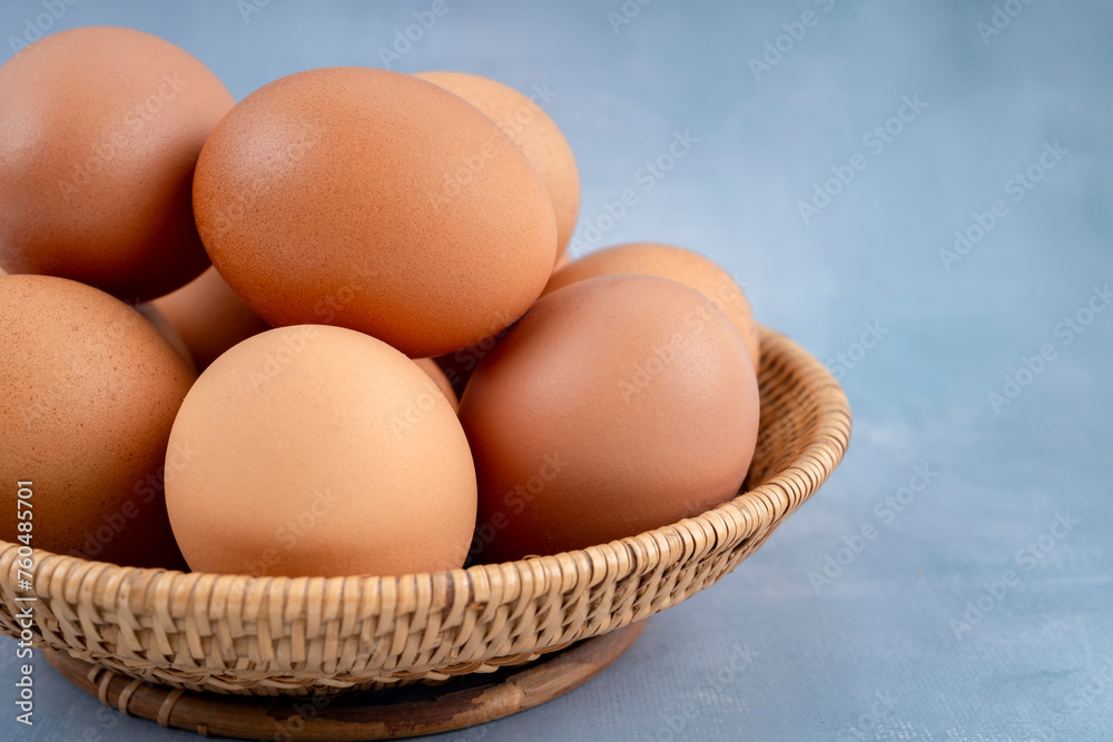 Freshness chicken eggs in wooden weave basket on blue wooden. Freshness chicken eggs in wooden weave basket on blue wooden.