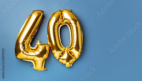Banner with number 40 golden balloon with copy space. forty years anniversary celebration concept on a blue background. photo