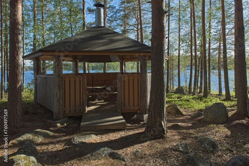 Wooden tourist shelter with fire place in forest on the island of Kalainsaari, Päijänne National Park, Finland. photo