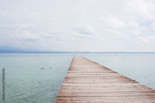 Old wooden pier over Garda lake, no people © Majopez