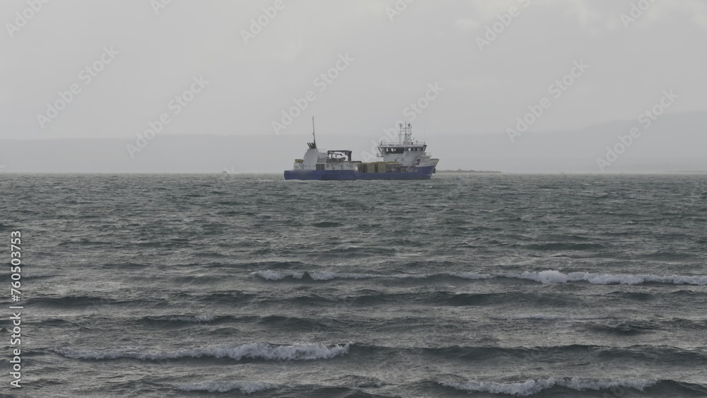 Gloomy Day at Sea: Fishing Vessel Facing Rough Waves