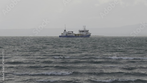Gloomy Day at Sea: Fishing Vessel Facing Rough Waves