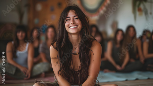caucasion women, brunette, fit sitting smiling leading a session in a meditation class photo
