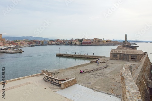 Venetian lighthouse on the end of stone pier at Chania in spring, Crete, Greece.