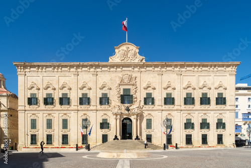 Valletta, Malta - June 1st 2020: The Maltese flag flying over the Auberge de Castille built in the 1740’s which has been used as the Office of the Prime Minister of Malta since 1972. photo