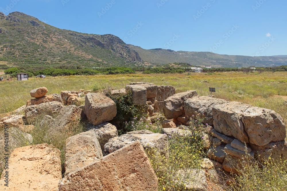 Landscape view of ancient City of Phalasarna archaeological site with stone ruins in sunny spring weather, Falasarna, Crete, Greece.