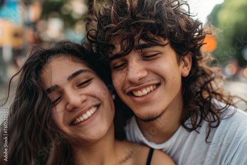 young couple hugging on the street smiling