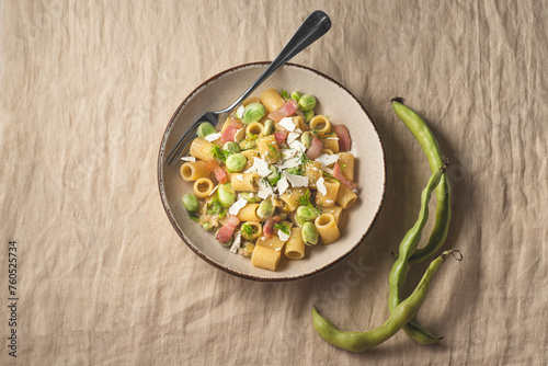 Sicilian traditional pasta with fave beans, green onions, pancetta, wild fennel and  ricotta salata  (salt ricotta). Poor cuisine, la cucina povera of Sicily.. Spring, Easter recipes, rustic style photo