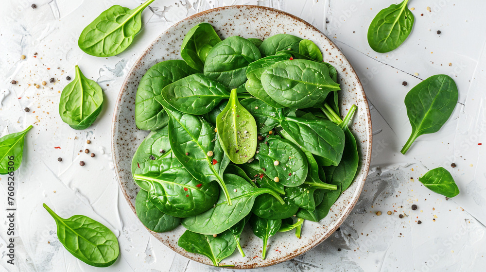 Obraz premium Fresh spinach leaves on white plate. Healthy vegan food, Top view сreated with Generative Ai