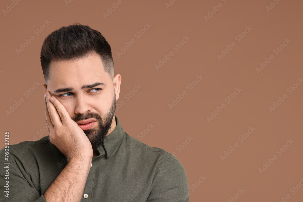 Portrait of sad man on brown background, space for text Portrait of sad man on brown background, space for text