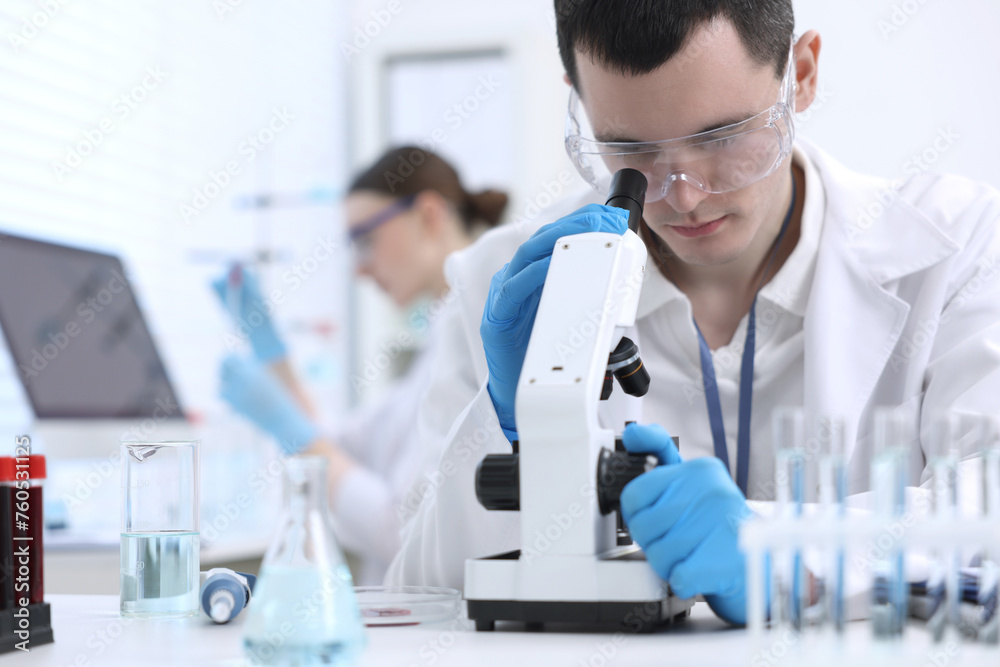 Scientist working with microscope in laboratory. Medical research Scientist working with microscope in laboratory. Medical research
