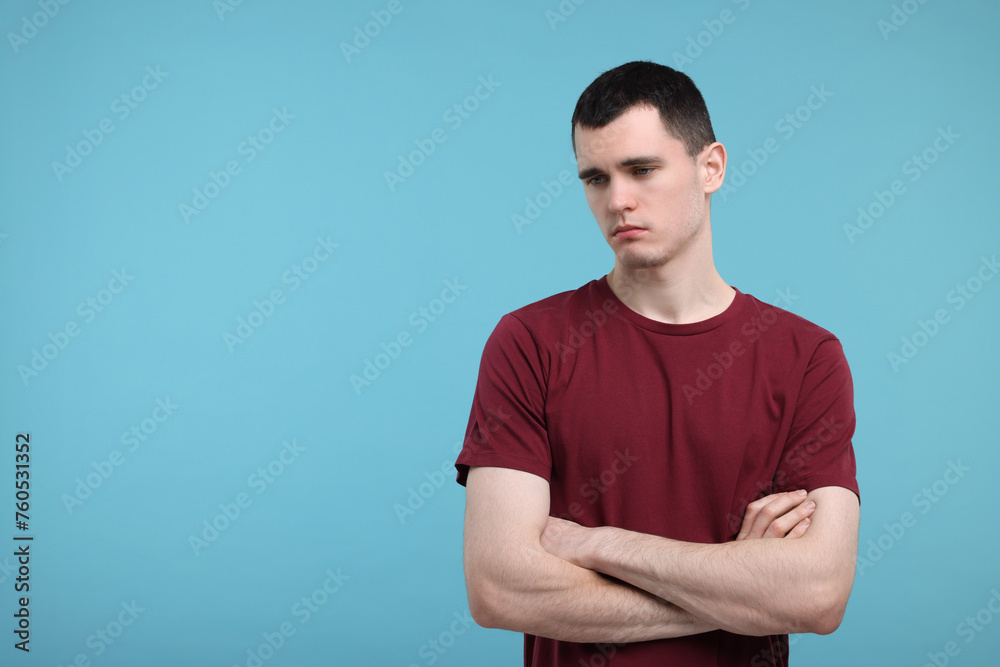 Portrait of sad man on light blue background, space for text Portrait of sad man on light blue background, space for text