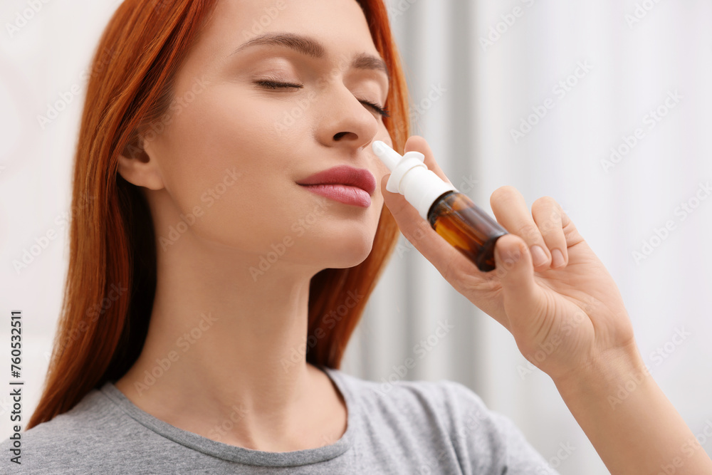 Medical drops. Woman using nasal spray at home Medical drops. Woman using nasal spray at home