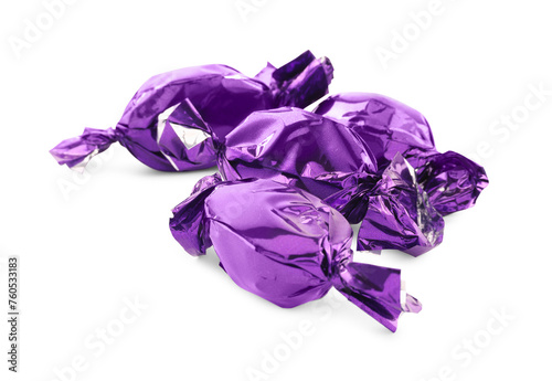 Candies in purple wrappers isolated on white