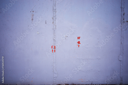 Plain street wall with painted red symbols backdrop
