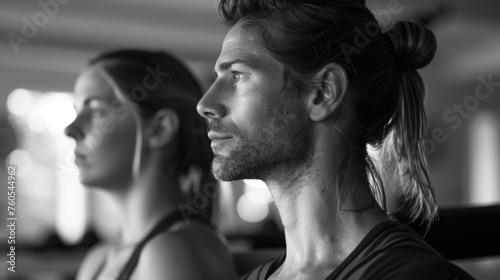 Focused male and female practicing Pilates in a serene studio environment