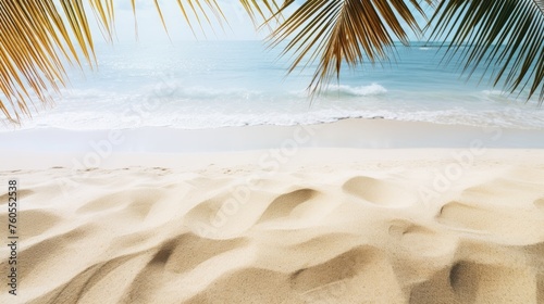 Tropical leaves on the background of sea waves on a sandy beach. The concept of recreation, vacations, tourism.