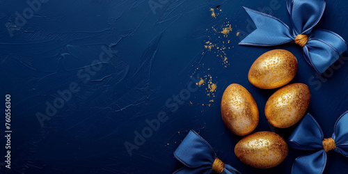 gold and blue easter eggs on a blue background. Easter frame of eggs painted in blue gold color. Flat lay, top view. Copy space for text.  © Planetz