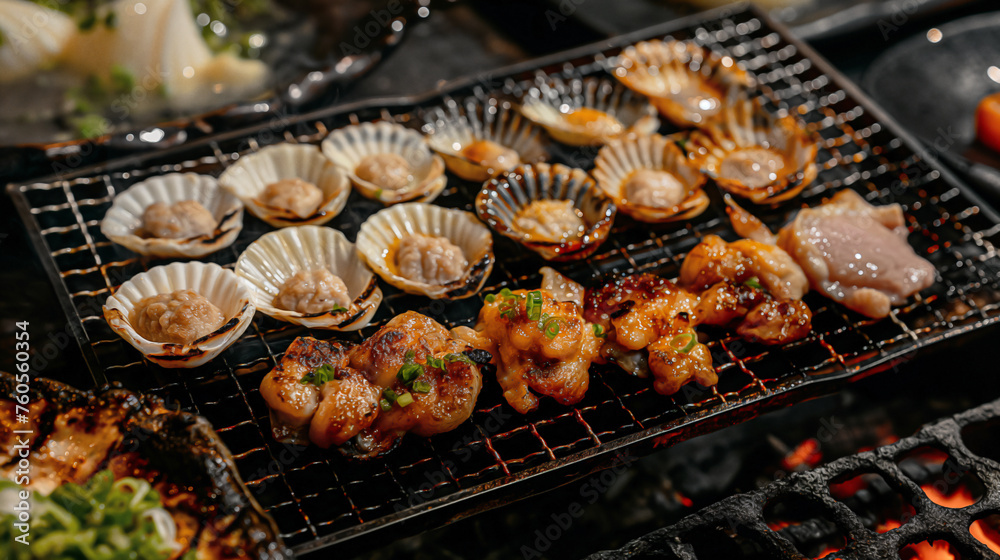 A top down style shell grilled sits on a black background dropped by a light soy-based sauce