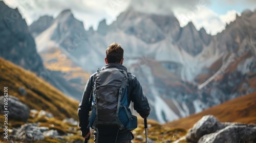 Hikers walking in forest with poles on path in mountains. Man traveler hiking together with backpacks and poles .