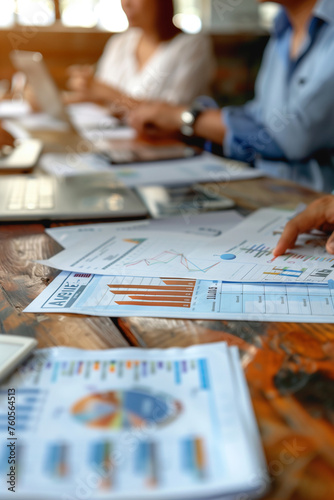 Financial reporting and audit concept. Bills charts statements and business people arrounf the table. High quality photo