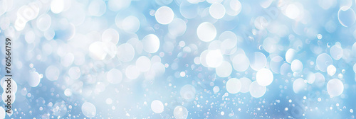 light blue background with white glitter and bokeh, shiny snowflakes falling, sparkling, blurred, shimmering.blue white bokeh blur circle variety Dreamy soft focus wallpaper backdrop,banner photo