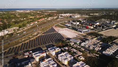 Aerial view of industrial zone with fuming chimneys. Heavy industry from above. Sunset. Coal-fired power station with solar panels and highway in Dominican Republic, Czech Republic, European Union