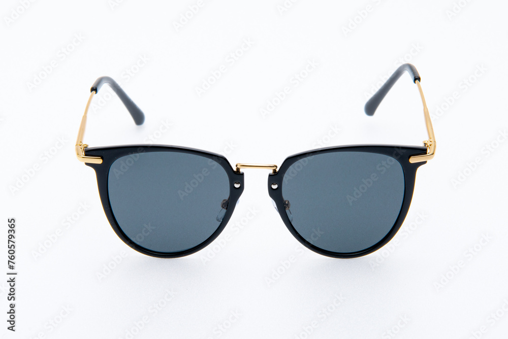 Fashion sunglasses black and gold frames on the white background. Fashion sunglasses black and gold frames on the white background.