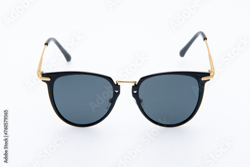Fashion sunglasses black and gold frames on the white background.