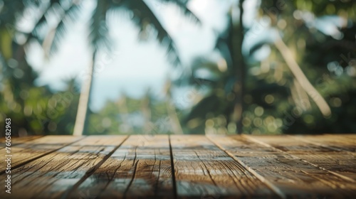 A wooden table looking out to a blurred tropical landscape