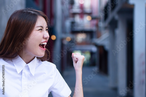 Satisfying  happy  excited asian woman shouting out loud