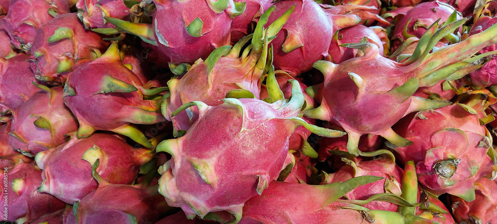 banner of fresh ripe dragon fruit lying on a market display, fruit texture or background