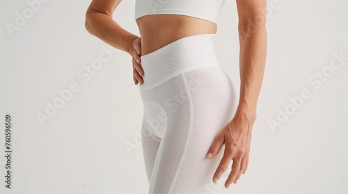 A fit older woman shows off her toned physique and excellent skin quality a testament to healthy living and physical activity at any age. Aging model. Menopause and weigh