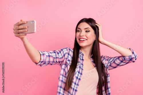 Portrait of her she nice attractive cute charming fascinating shine lovely lovable cheerful straight-haired lady holding in hand cell making taking selfie isolated over pink pastel background