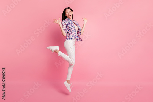 Full length side profile body size photo amazing beautiful her she lady jump high party holiday wear shoes casual checkered plaid shirt white jeans denim clothes outfit isolated pink background