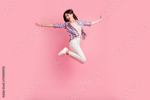 Full length side profile body size photo yell amazing beautiful her she lady jump high sporty competition wear shoes casual checkered plaid shirt white jeans denim clothes isolated pink background photo