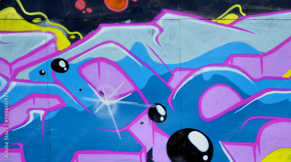 Colorful background of graffiti painting artwork with bright aerosol outlines on wall. Old school street art piece made with aerosol spray paint cans. Contemporary youth culture backdrop