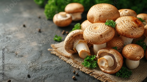 Fresh shiitake mushrooms with parsley on grey table, closeup photo