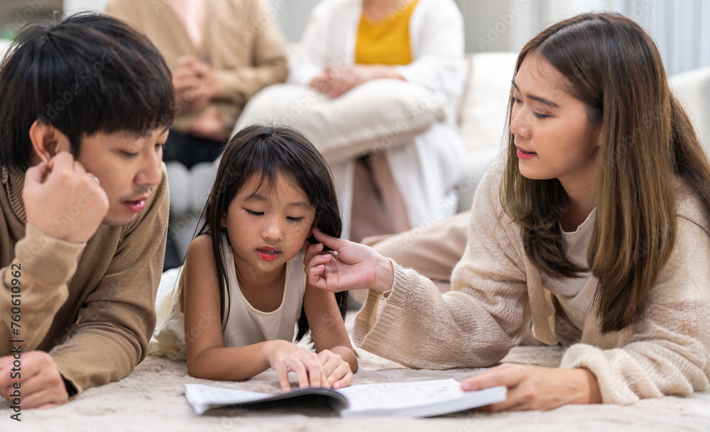 Portrait happy love asian family father and mother teach little daughter asian girl learn and study.Mom and asian young girl reading book making lessons in homeschool at home.Education