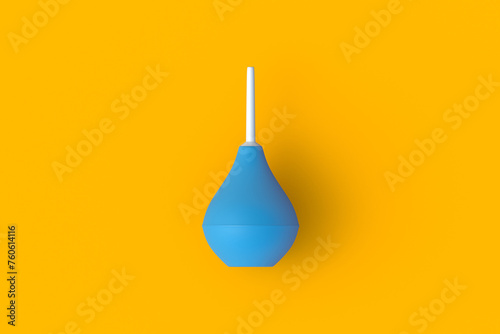 Enema on orange background. Rubber douching bag. Pear shaped syringe bulb. Medical clyster. Nasal aspirator. Laboratory tool. Constipation treatment. Top view. 3d render photo