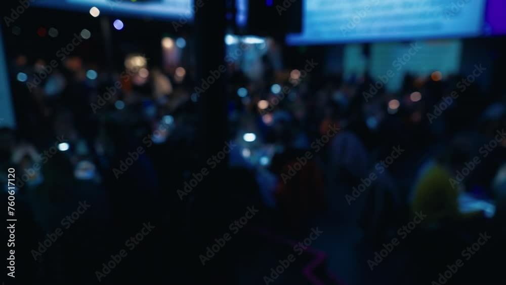 Out-of-focus video reveals the energetic scene of friends having fun, drinking, and engaging in the quiz event Out-of-focus video reveals the energetic scene of friends having fun, drinking, and engaging in the quiz event