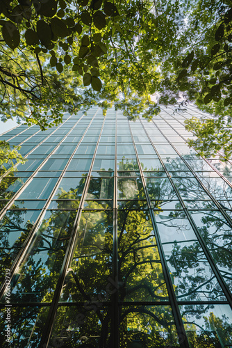 Sustainable green building. Eco-friendly building. Sustainable glass office building with tree for reducing carbon dioxide. Office with green environment. Corporate building reduce CO2. © Artinun