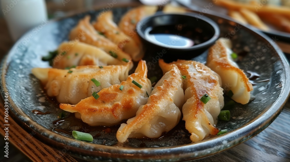 Fried dumplings with soy sauce on plate, closeup Fried dumplings with soy sauce on plate, closeup