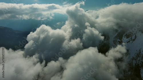 Flying through clouds between mountains