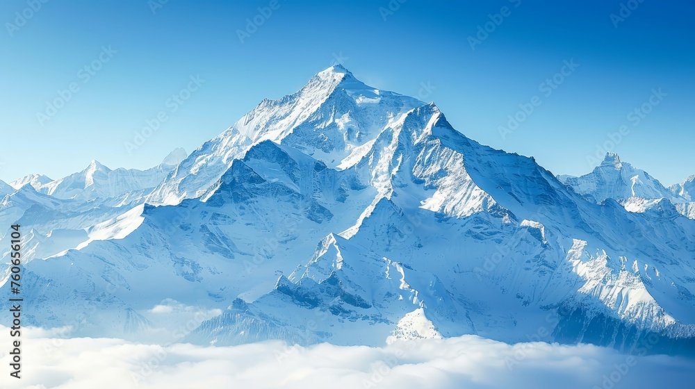 The imposing peak of a snow-covered mountain soars above a sea of clouds against a clear sky. The imposing peak of a snow-covered mountain soars above a sea of clouds against a clear sky.
