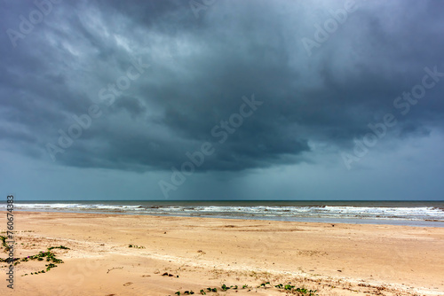 Dark rain clouds over the sea at Sargi beach in Serra Grande on the coast of Bahia