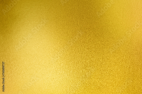 Luxury gold gradient light shiny glitter texture background. Golden shiny foil gradient metallic metal polished sheet with gloss light reflection, vibrant golden metal wall wallpaper