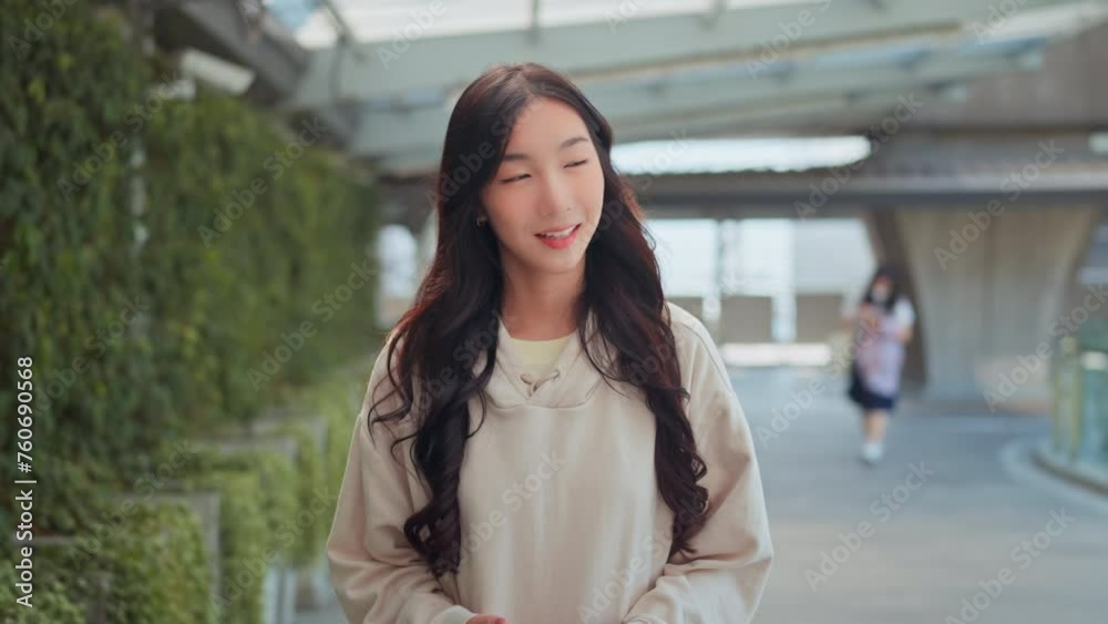 Happy young asian woman using mobile phone with chatting online, Female walking in the city using social media on smartphone, Technology Happy young asian woman using mobile phone with chatting online, Female walking in the city using social media on smartphone, Technology