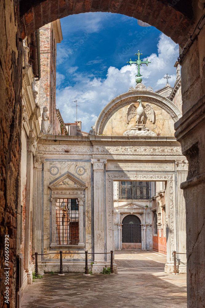 Campo San Giovanni (St John Square) in Venice, with renaissance marble screen erected in 1481, seen from narrow lane