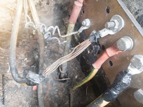 Burnt ground cable, failure in the industrial electrical installation grounding system. Failure earth system concept.